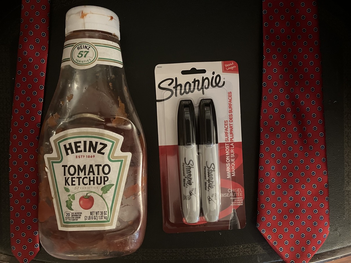 Ketchup bottle, black sharpies, red necktie