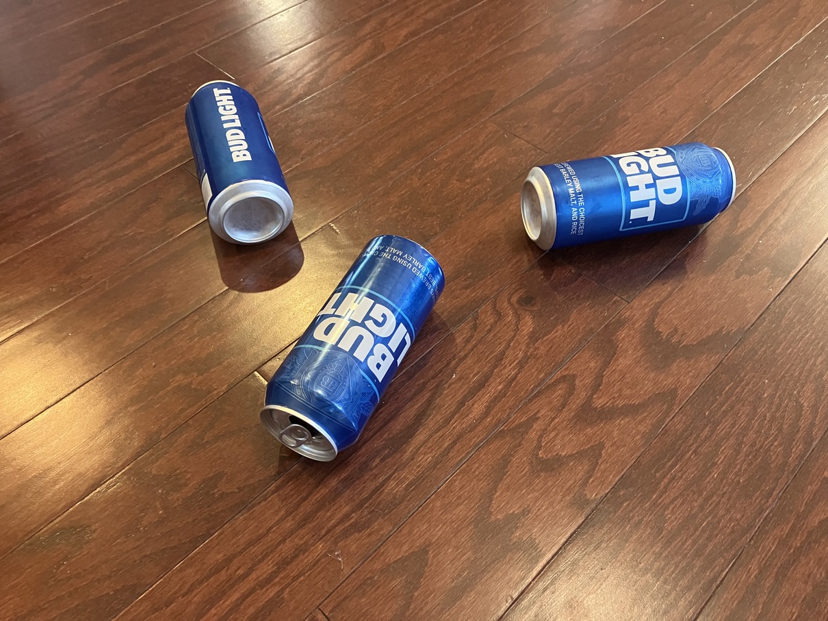 Three Bud Light cans on floor